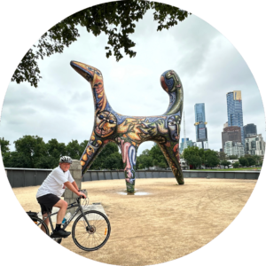 Stuart cycling in Melbourne. Sculpture is Angel by Deborah Halpern